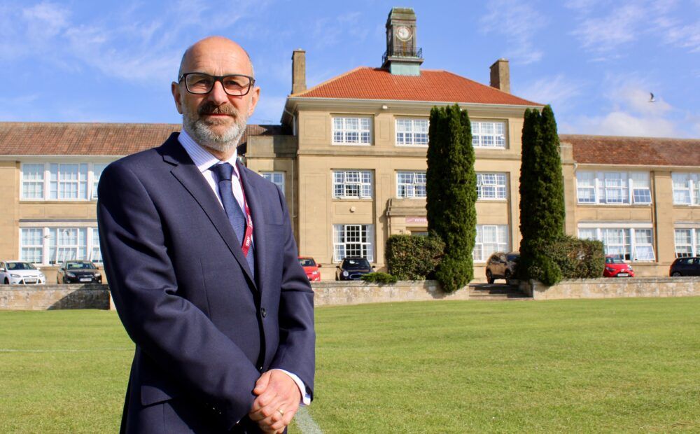 Male Standing In Front Of Pittville School